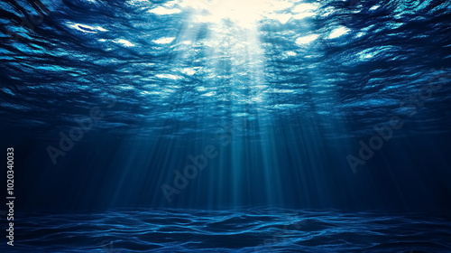Abstract Image of Tropical Underwater Dark Blue Deep Ocean Wide Nature Background with Rays of Sunlight: An abstract underwater scene with dark blue ocean depths and rays of sunlight