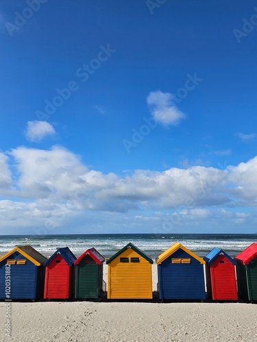 Colorful beachhuts on Muizenberg beach in Cape Town. The huts are a big domestic and international tourist attraction.