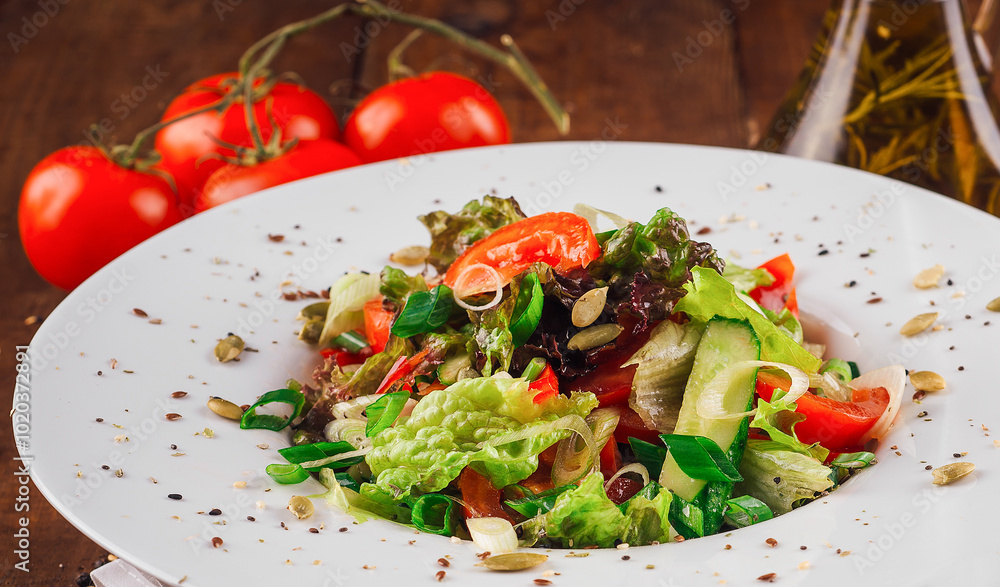 Fresh vegetable salad with pumpkin seeds on wooden table Fresh vegetable salad with pumpkin seeds on wooden table