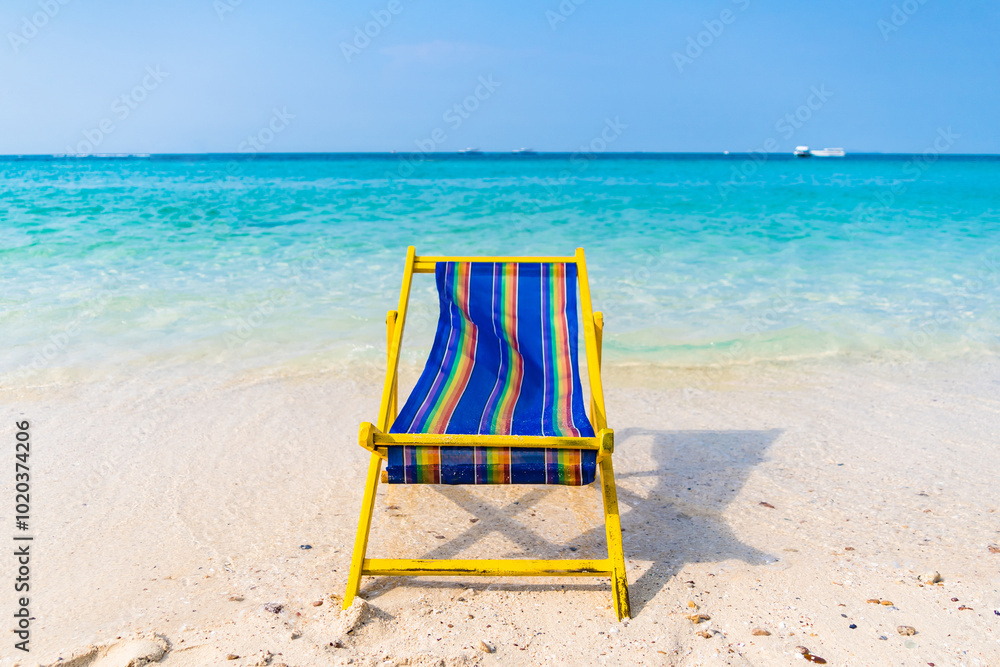 Serene Tropical Beach with Vibrant Beach Chair Serene Tropical Beach with Vibrant Beach Chair