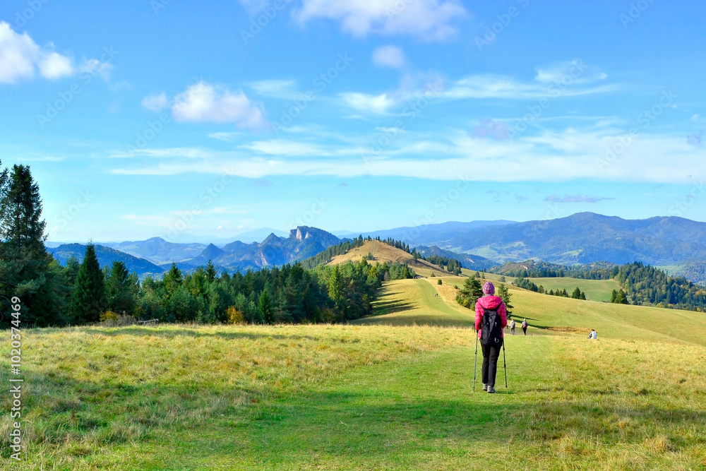 Scene in Pieniny mountains on a warm and sunny autumn day.
Group of tourists backpacker on hiking trail in the mountains in autumn sunny day, against the backdrop of unreal views. Scene in Pieniny mountains on a warm and sunny autumn day.
Group of tourists backpacker on hiking trail in the mountains in autumn sunny day, against the backdrop of unreal views.