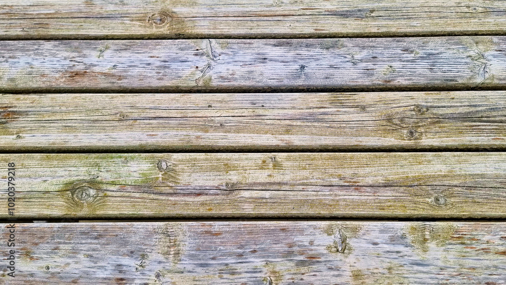 Weathered wooden deck planks. A close-up of weathered wooden deck planks, showcasing the natural texture and grain patterns. Weathered wooden deck planks. A close-up of weathered wooden deck planks, showcasing the natural texture and grain patterns.