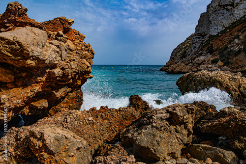 The Granadella cove with crystal-clear waters in Javea, Alicante, in the Spanish Mediterranean photo