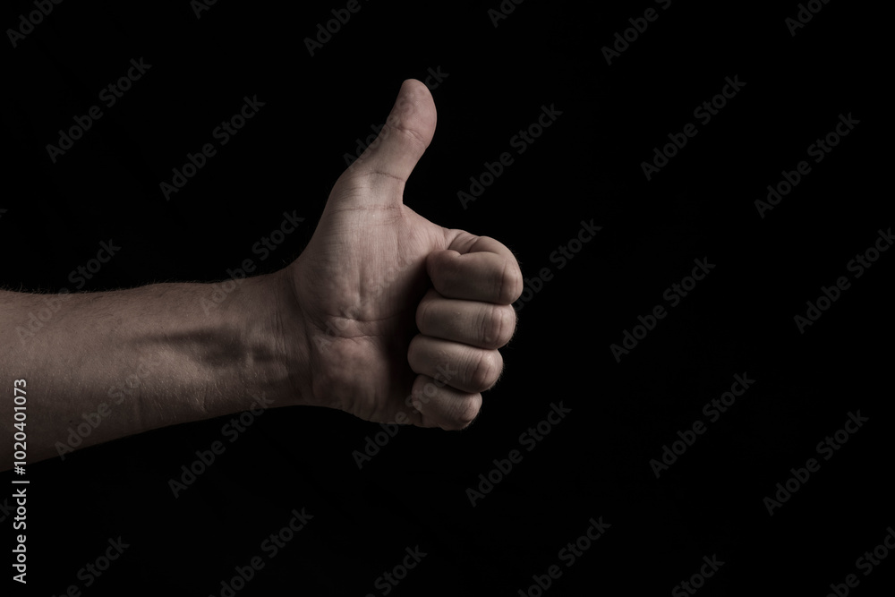 thumbs up isolated on black background thumbs up isolated on black background