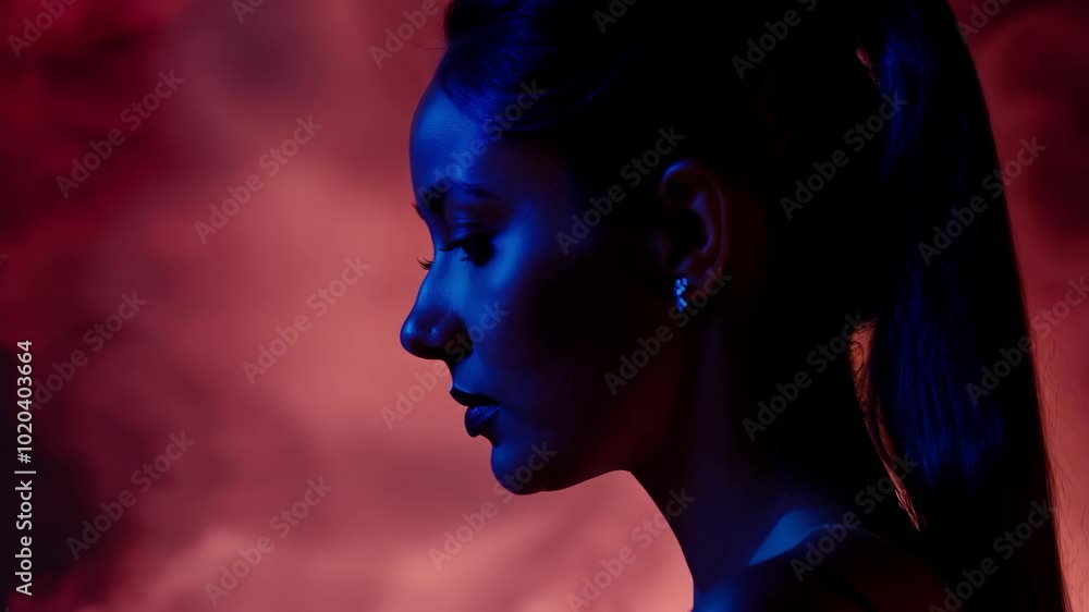 Dramatic portrait of a woman in blue and red lighting Dramatic portrait of a woman in blue and red lighting