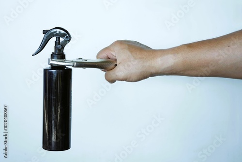 Close-up of a plumber's hand holding a metal faucet wrench, isolated on white background photo