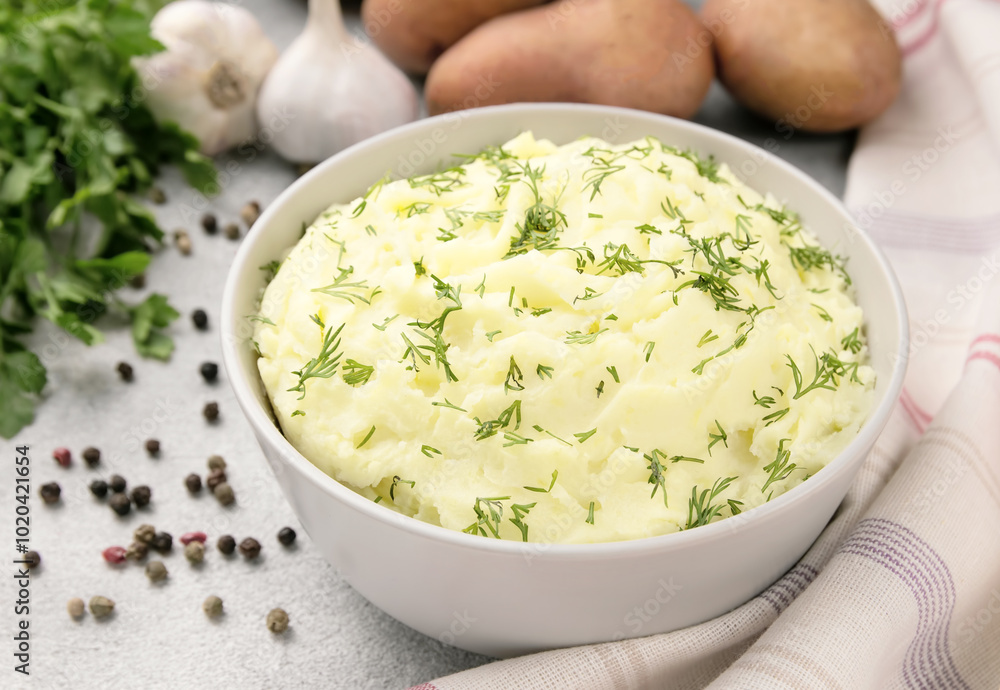Mashed potatoes in white bowl on grey concrete background. Healthy food Mashed potatoes in white bowl on grey concrete background. Healthy food