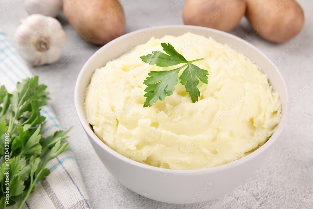 Mashed potatoes in white bowl on grey concrete background. Healthy food Mashed potatoes in white bowl on grey concrete background. Healthy food