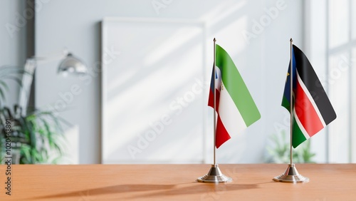 FLAGS OF EQUATORIAL GUINEA AND SOUTH SUDAN ON TABLE