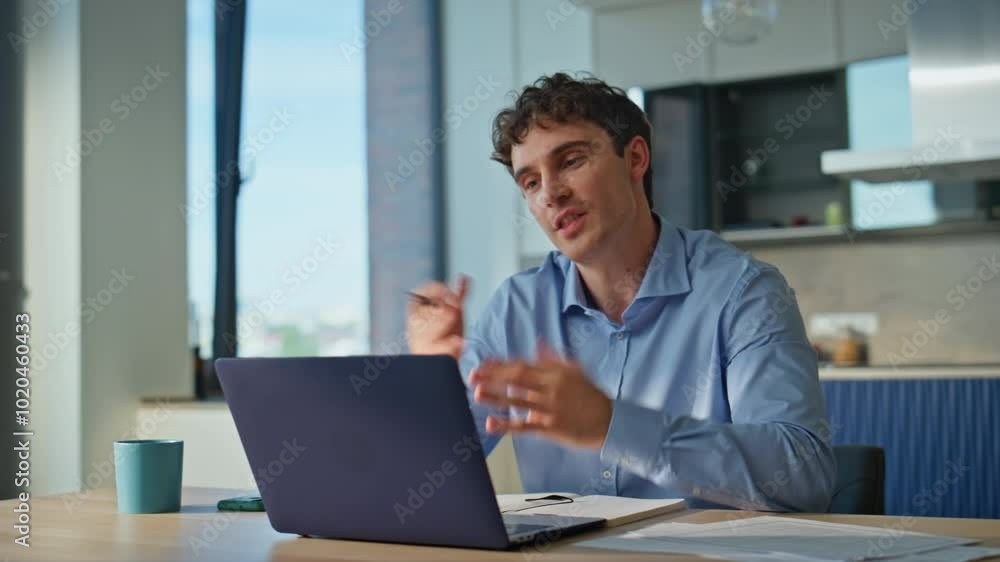Smiling man talking virtual meeting discussing projects at home kitchen closeup. Smiling man talking virtual meeting discussing projects at home kitchen closeup.
