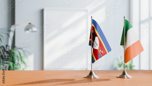 FLAGS OF ESWATINI AND IRELAND ON TABLE photo