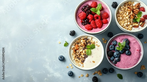 Healthy smoothie bowls for children, filled with berries, granola, and nuts, set against a clean background with copy space