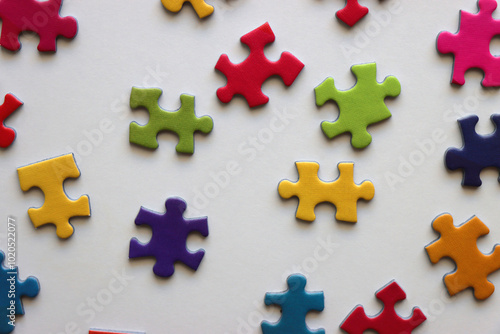 Colorful jigsaw puzzle pieces on white background. Flat lay.