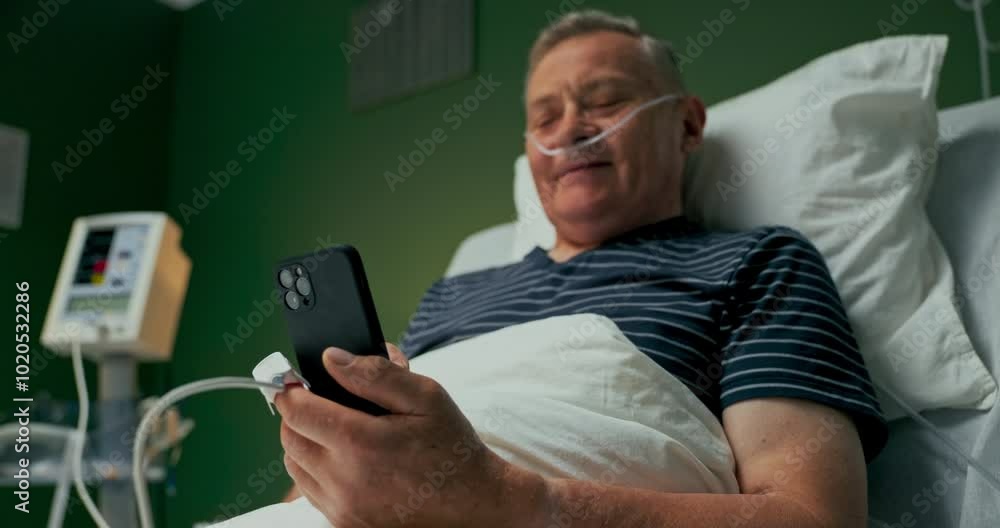 Senior patient, holding the phone, engages in video calls, connecting visually with family members who couldn't be there in person.