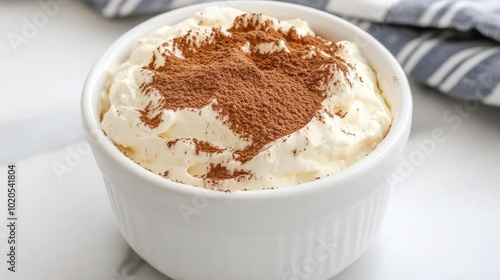 A beautifully arranged top view of a tiramisu cake, showcasing its layered structure and creamy mascarpone frosting. The dusting of cocoa powder adds an elegant touch to this delightful dessert.