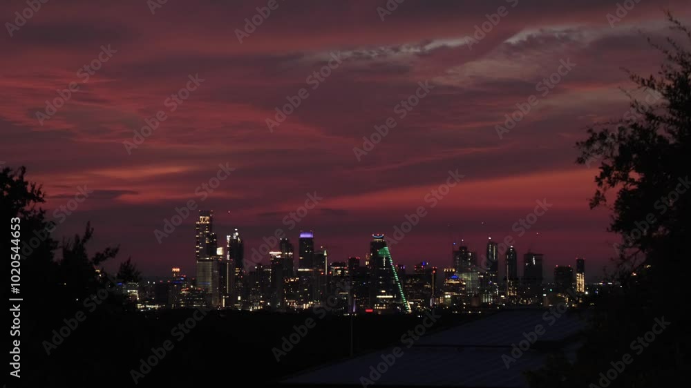 Austin, Texas skyline featuring a pink and purple sunrise. Austin, Texas skyline featuring a pink and purple sunrise.