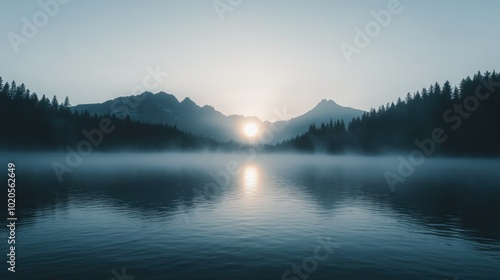 Serene Sunrise Over Fog-Covered Mountain Lake