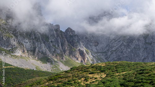 Obraz na płótnie A dark, jagged mountain peak shrouded in thick clouds and mist