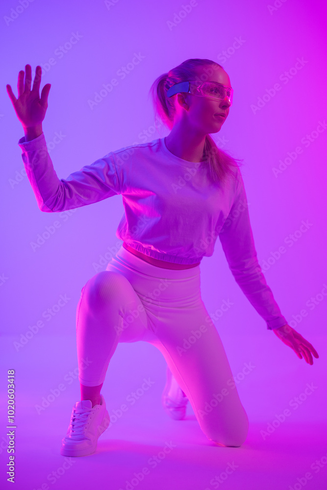 Woman interacting with virtual reality in vibrant neon colored lighting Woman interacting with virtual reality in vibrant neon colored lighting