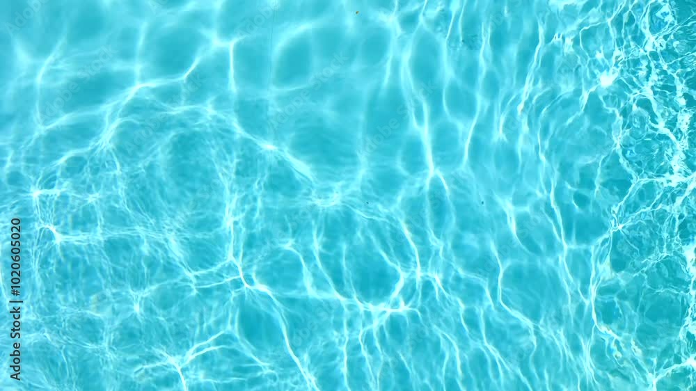 Blue water in the swimming pool with light reflections. Slow motion Blue water in the swimming pool with light reflections. Slow motion