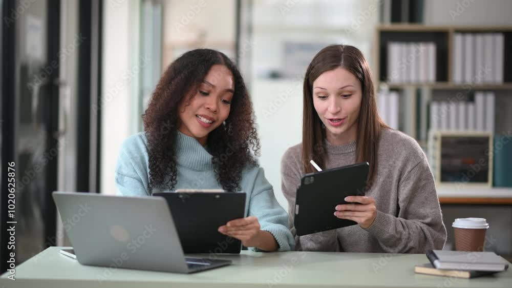 Businesswoman leading team meeting and using tablet and laptop computer with financial Businesswoman leading team meeting and using tablet and laptop computer with financial