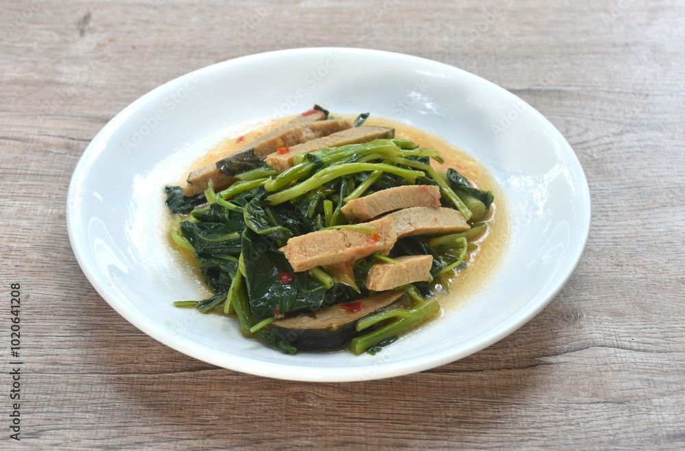 fried Chinese kale with slice gluten vegetarian food on plate fried Chinese kale with slice gluten vegetarian food on plate