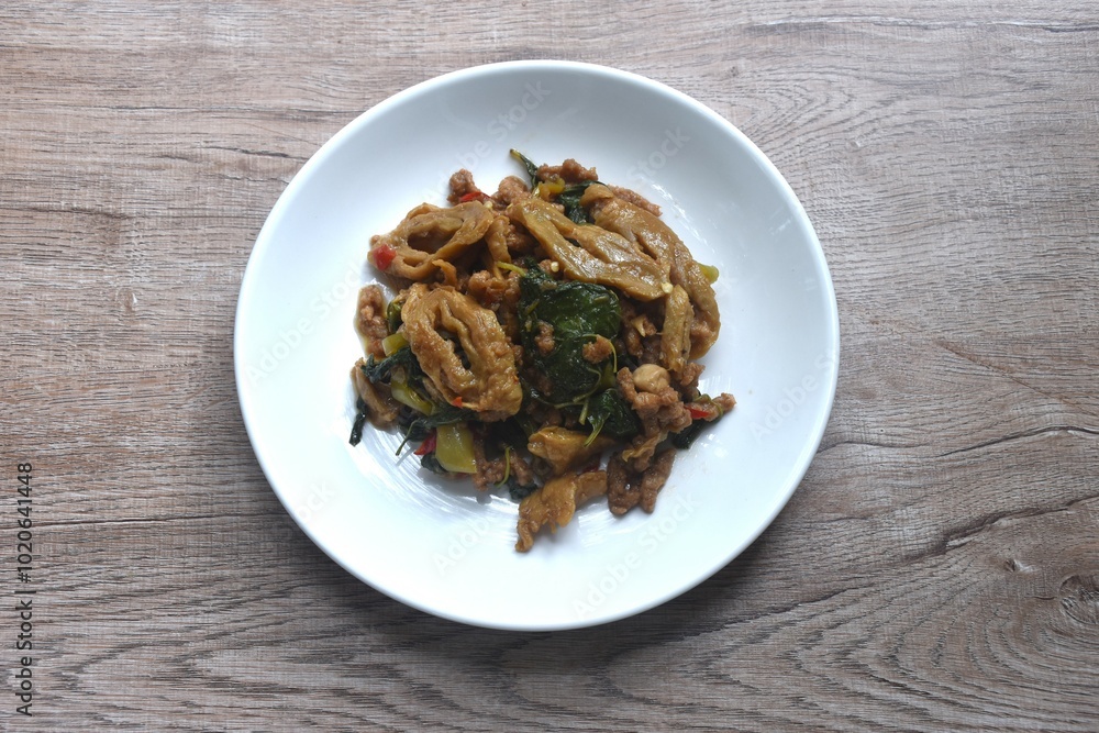 spicy stir fried chop gluten protein with basil dressing slice chili vegetarian fusion food on plate spicy stir fried chop gluten protein with basil dressing slice chili vegetarian fusion food on plate