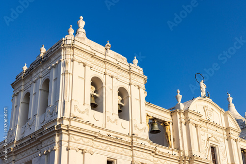Closeup of sculptures and bell of white cathedral of Leon in Nicaragua
