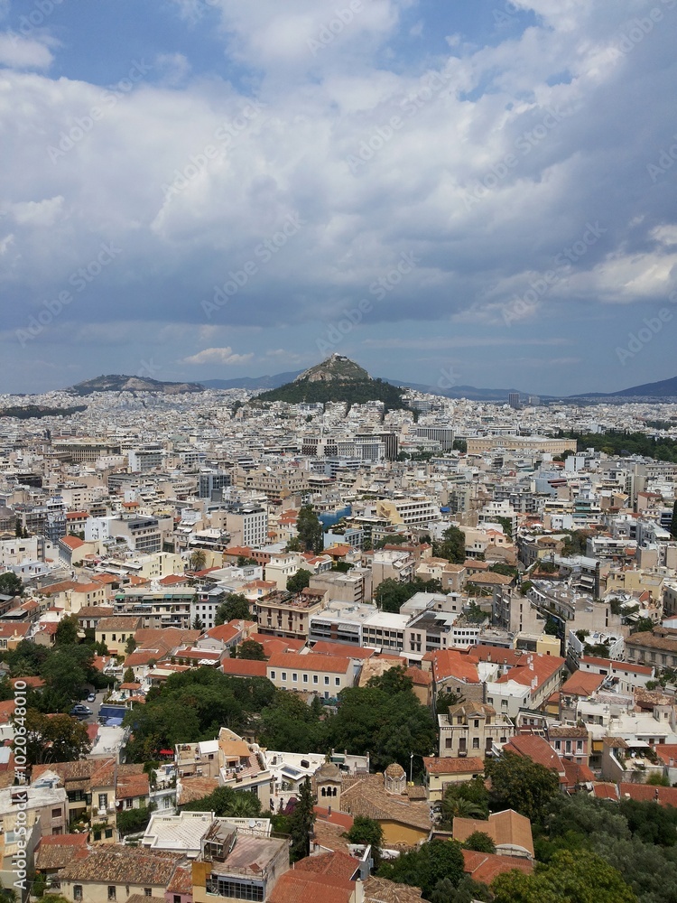 View of Athens from a height. Panoramic view of the city of Athens, Greece, from a height, under a cloudy sky. View of Athens from a height. Panoramic view of the city of Athens, Greece, from a height, under a cloudy sky.
