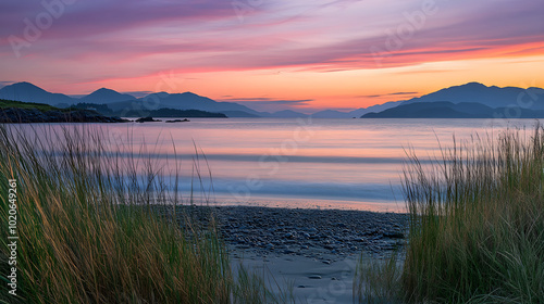 Serene Coastal Sunset Panorama with Vibrant Sky and Tranquil Waters Framed by Distant Mountains