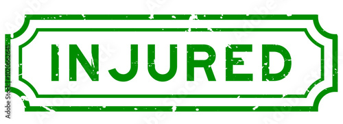 Grunge green injured word rubber seal stamp on white background