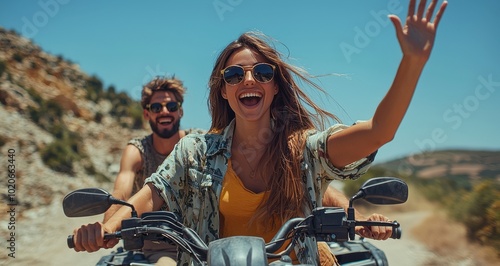 Young couple enjoying a thrilling adventure ride on an ATV through a scenic countryside path under a clear summer sky