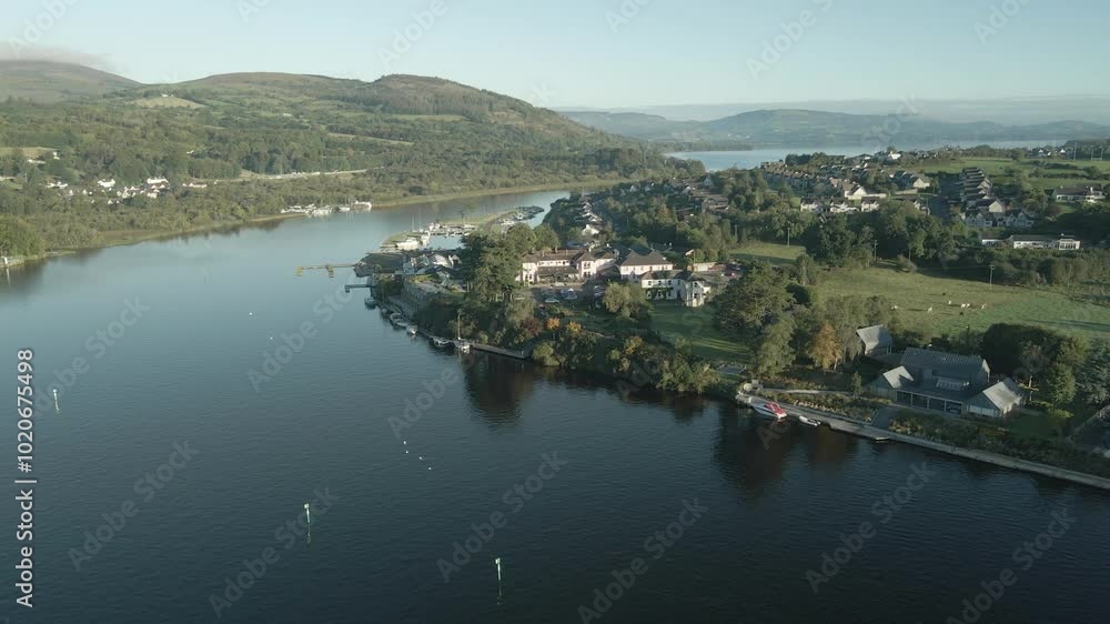 Killaloe town along a peaceful river with lush hills in county limerick, ireland, aerial view Killaloe town along a peaceful river with lush hills in county limerick, ireland, aerial view