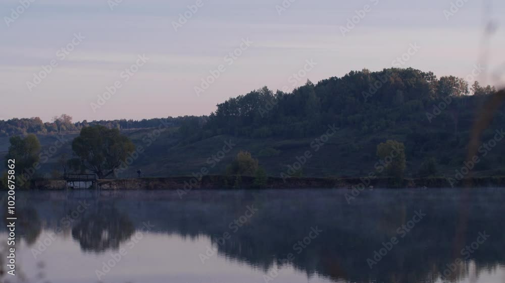 Calm lake water with green trees landscape and fields Calm lake water with green trees landscape and fields