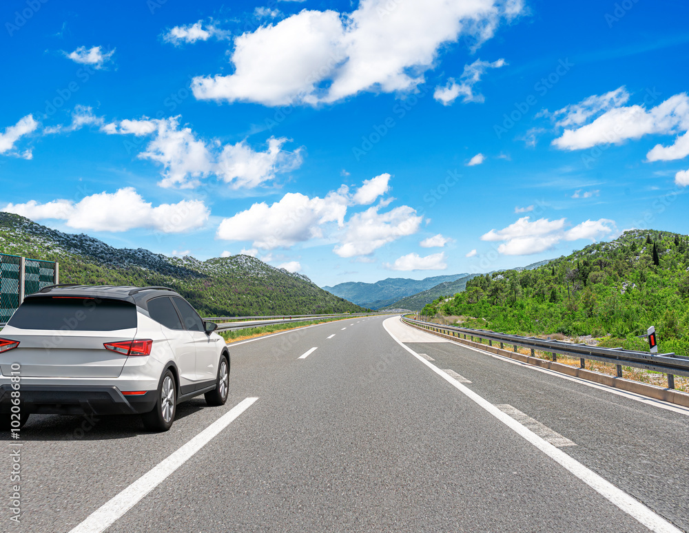 The car is driving along the highway surrounded by picturesque nature. The car is driving along the highway surrounded by picturesque nature.
