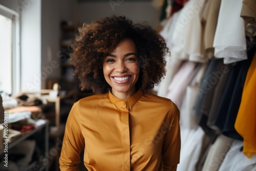 Portrait of a smiling female fashion designer in store