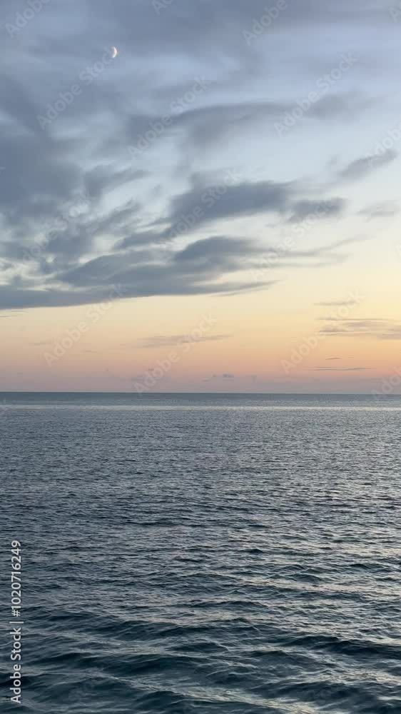 Calm ocean and dusk clouds sky, vertical video. Calm ocean and dusk clouds sky, vertical video.