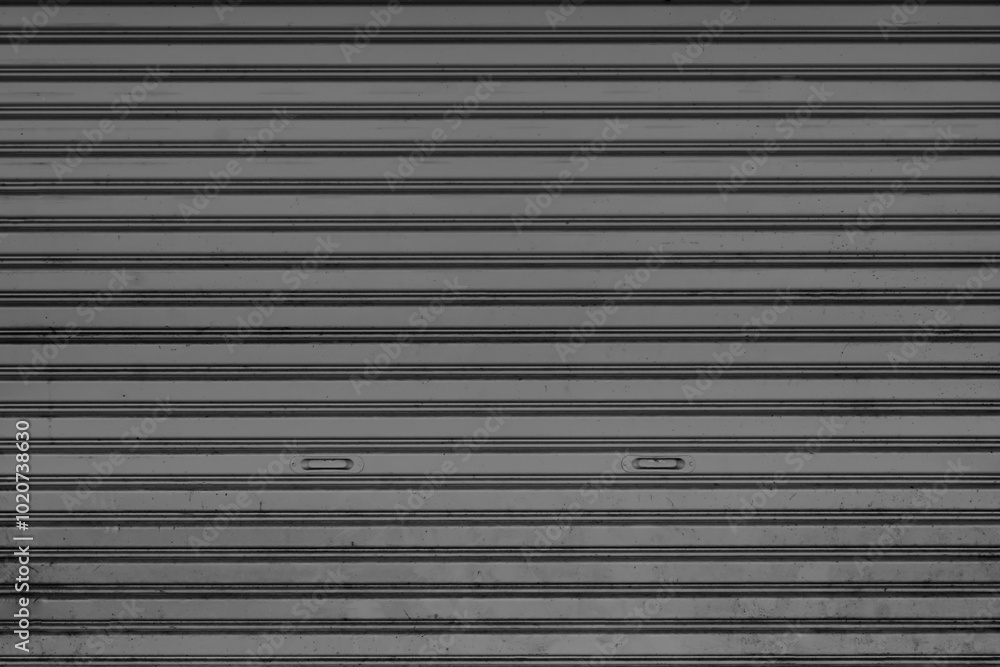 Obraz premium The surface of the dark gray rolling door was old and dusty.