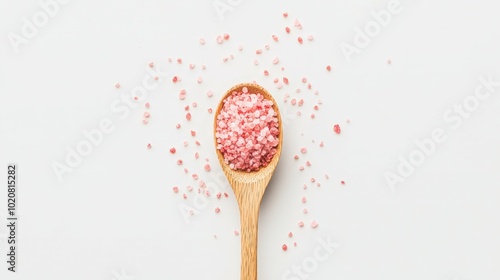 Wooden spoon filled with pink bath salts photo