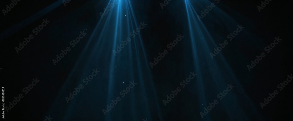 A blue light is shining on a dark background. The light is coming from the left side of the image A blue light is shining on a dark background. The light is coming from the left side of the image