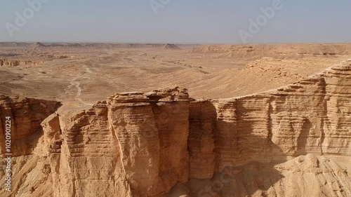 Camera drone flies backwards over Edge of the World, a popular tourist destination near Riyadh