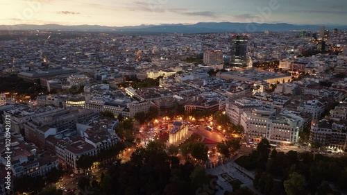 Madrid drone view in the evening with night lights, downtown Madrid, Puerta de Alcala crossroads in Madrid in the evening aerial view, capital of Spain at night