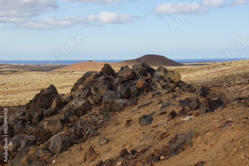 desertic landscape of volcano and caldera on the sea side