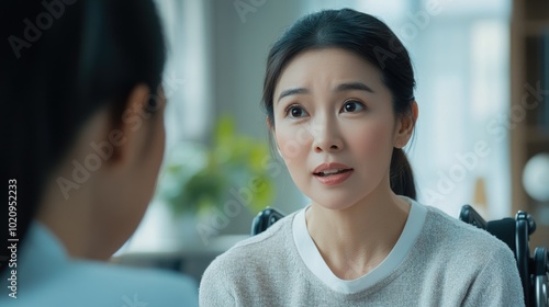 Wallpaper Mural A woman in a wheelchair engaged in conversation with another woman Torontodigital.ca