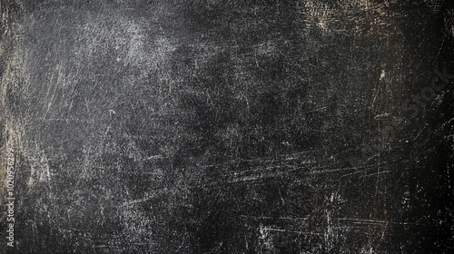 A scratched black surface with visible marks and scuffs, creating a distressed and grungy texture.