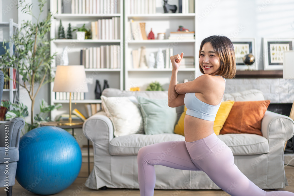 Portrait of sport slim fit strength asian woman training in sportswear relax and practicing yoga, fitness, exercise, wellness, workout, sport at home.Diet concept.Fitness and healthy lifestyle Portrait of sport slim fit strength asian woman training in sportswear relax and practicing yoga, fitness, exercise, wellness, workout, sport at home.Diet concept.Fitness and healthy lifestyle