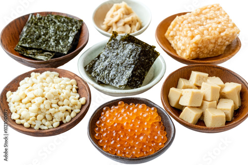 Variety of ingredients for sushi preparation, including seaweed, tofu, and fish roe, arranged in wooden bowls. photo