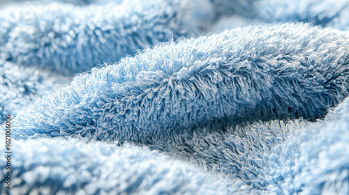 A soft and fluffy blue towel, showcasing its luxurious texture and inviting comfort, perfect for enhancing the sense of coziness and relaxation at home.