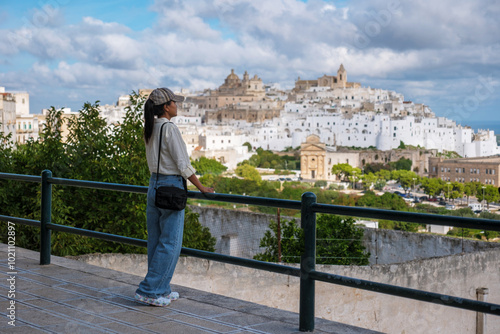Slika na platnu Ostuni In the enchanting region of Puglia, a visitor stands on a terrace, captiv