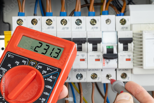 Hand Testing Electrical Circuit with Multimeter
